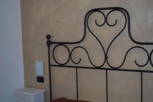 a close up of a bed with a black frame at Hotel San Nicola in Alassio