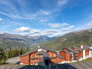 a view of a hotel with mountains in the background at Appartement La Plagne, 2 pièces, 6 personnes - FR-1-353-72 in La Plagne