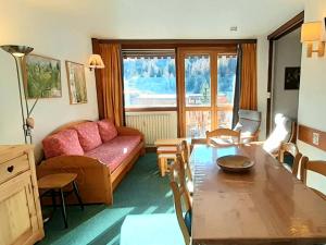 a living room with a couch and a table at Appartement La Plagne, 3 pièces, 6 personnes - FR-1-351-2 in La Plagne
