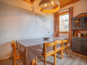 a kitchen with a table and chairs in a room at Appartement Valmorel, 2 pièces, 6 personnes - FR-1-356-329 in Valmorel