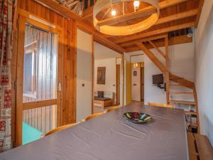 a dining room with a table and a staircase at Appartement Valmorel, 2 pièces, 6 personnes - FR-1-356-329 in Valmorel
