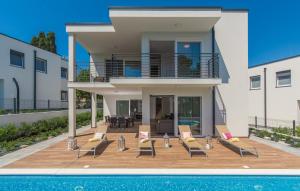 a villa with a swimming pool and a house at VILA PALISKA in Pula
