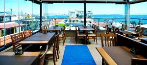 a restaurant with tables and chairs and a view of the ocean at Seraglio Hotel & Suites in Istanbul
