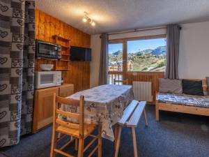 a small room with a table and a couch at Appartement La Plagne, 2 pièces, 6 personnes - FR-1-351-75 in La Plagne