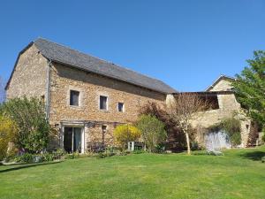 a large brick building with a yard in front of it at LA GRANGE DU RIAL in Bournazel