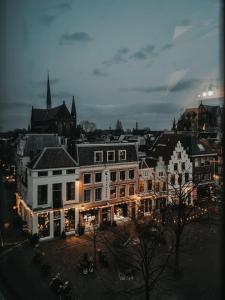 a group of buildings in a city at night at Mother Goose Hotel in Utrecht