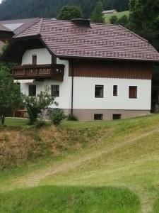 a large white house with a brown roof at Ferienhaus Sonnenseite in Weisspriach