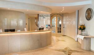 a hotel lobby with a reception counter and a star on the floor at Rhodos Horizon Blu-Adults Only in Rhodes Town