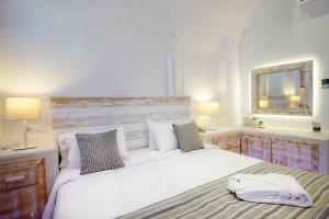 a bedroom with a large white bed and a mirror at Rhodos Horizon Blu-Adults Only in Rhodes Town