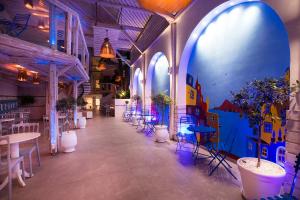 a hallway with tables and chairs in a restaurant at Rhodos Horizon Blu-Adults Only in Rhodes Town