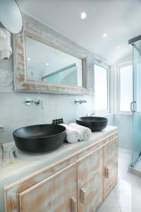 a bathroom with two sinks on top of a counter at Rhodos Horizon Blu-Adults Only in Rhodes Town