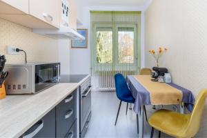 a small kitchen with a table and a microwave at Moonlight Central Apartments in Oradea