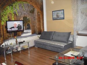 a living room with a couch and a flat screen tv at Apartament Rodzinny Hana in Kudowa-Zdrój