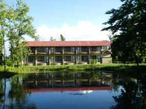 a building with a river in front of it at Lumbini Buddha Garden Resort in Lumbini