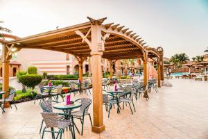 a group of tables and chairs under a pavilion at Charmillion Gardens Aquapark in Sharm El Sheikh
