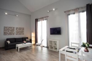 Televízia a/alebo spoločenská miestnosť v ubytovaní EM21 Apartamentos