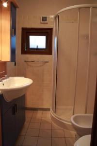a bathroom with a shower, sink, and toilet at Camping Free Beach in Marina di Bibbona