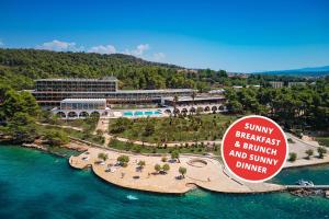 a resort on a island in a body of water at Arkada Hotel in Stari Grad