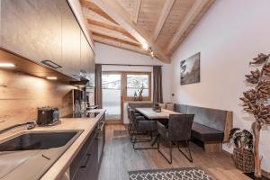 a kitchen with a table and a dining room at Landhaus Sonnenwiese in Sölden