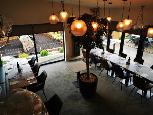 a restaurant with tables and chairs and a potted plant at The Balerno Inn in Edinburgh