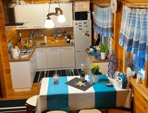 a small kitchen with a table and a refrigerator at Grey House in Dębki