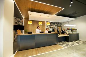 three people sitting at a counter in a restaurant at Staycity Aparthotels York in York