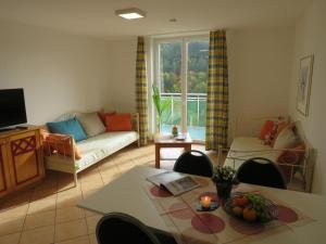 a living room with a couch and a table at Residenzpark Willingen Typ C in Willingen