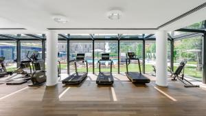 a gym with several treadmills and elliptical machines at Grand Hotel Victoria concept & spa, by R Collection Hotels in Menaggio