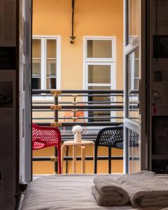 a room with a bed and two chairs on a balcony at Timeout Heritage Hotel Zagreb in Zagreb