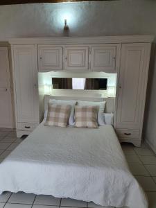 a bedroom with a large white bed with a headboard at Suite parentale Castillon du Gard in Castillon-du-Gard +16 photos