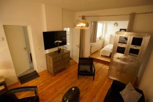 a living room with a television and a dresser at Fewo Kleine Münzenstraße 19 in Brandenburg an der Havel