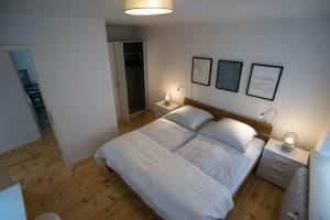 a bedroom with a large bed with two lamps on it at Fewo Kleine Münzenstraße 19 in Brandenburg an der Havel