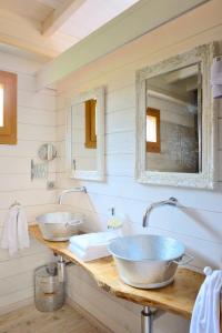 a bathroom with two sinks and a mirror at Cabane dans les arbres / Swin-golf de Cremin in Cremin