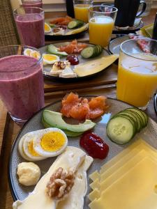 a table topped with plates of breakfast foods and drinks at North Experience Basecamp in Melen