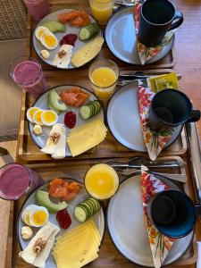 a table full of plates of food with eggs and fruit at North Experience Basecamp in Melen