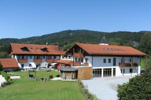 a group of buildings with a grass yard and trees at Bernrieder Hof in Bernried