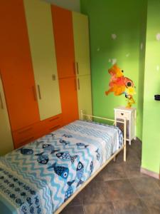 a bedroom with a bed and a colorful wall at Acqua Marina in Nicotera Marina +13 photos