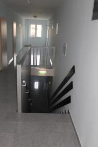 a stairway in a building with a black railing at Hotel Birten in Xanten
