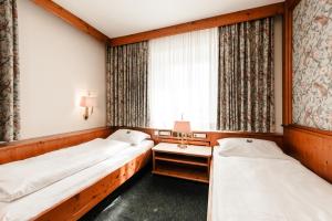 Postel nebo postele na pokoji v ubytování Hotel & Restaurant Ochsen Merklingen