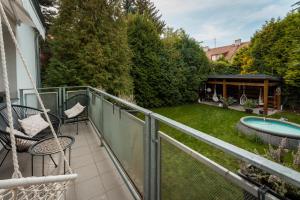 a balcony with a hammock and a yard at Apartmán s terasou in Olomouc
