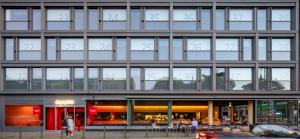 a building with many windows and a car in front at Casa Camper Berlin in Berlin