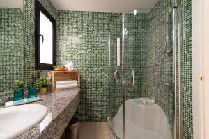 a bathroom with a shower and a tub and a sink at Sunshine Beach Villas in Puerto Rico de Gran Canaria