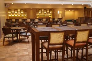 a restaurant with tables and chairs in a room at Sharayu One in Mapusa