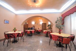 a restaurant with tables and chairs in a room at Hotel Piccolo in Termini Imerese