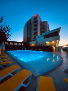 a swimming pool in front of a hotel at Hotel Avrora in Vityazevo