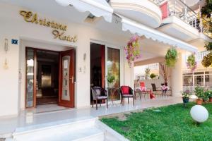 a villa with a garden and a christmas hotel at Christina Hotel in Olympiaki Akti