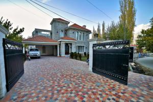 a large house with a driveway with two gates at Arish Luxury Suites in Skardu
