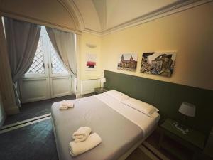 En eller flere senge i et værelse på Il Giardino Falcone