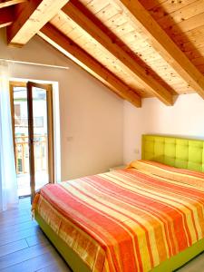 a bedroom with a bed and a large window at Villa Marilyn in Ledro