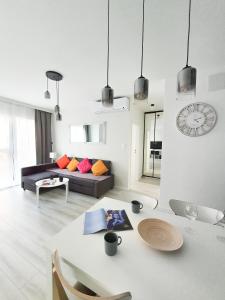 a living room with a couch and a table at Capital Apartments - Towarowa in Poznań